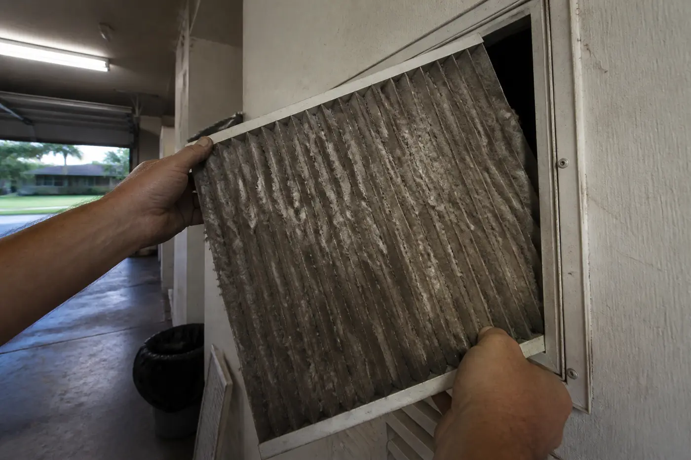 Dirty AC air filter packed with Florida pollen, pulled during AC maintenance in Tampa