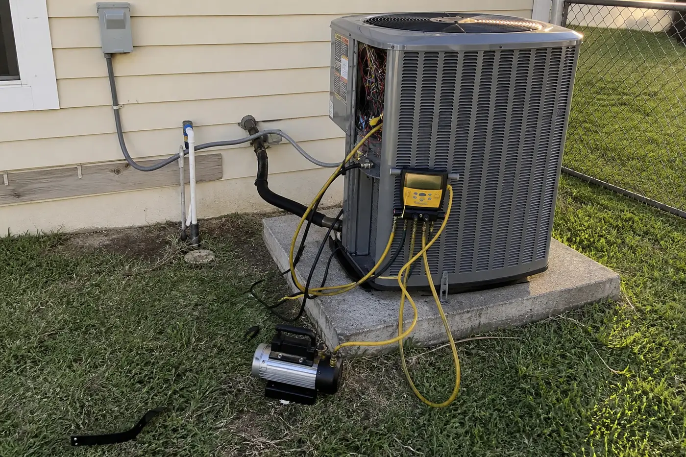 Vacuum pump and micron gauge on a new condenser during HVAC installation in Tampa