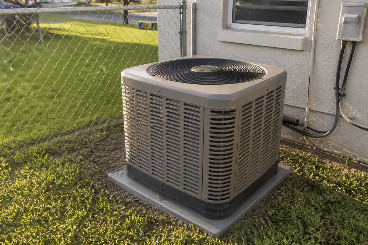 Rheem outdoor AC condenser installed in a Tampa Bay backyard