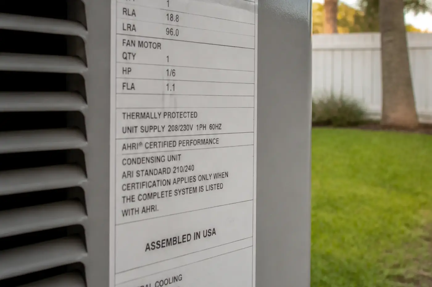 Outdoor AC condenser data plate where the SEER2 rating is printed